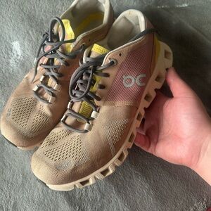 On Running Tan and Yellow Athletic Shoes